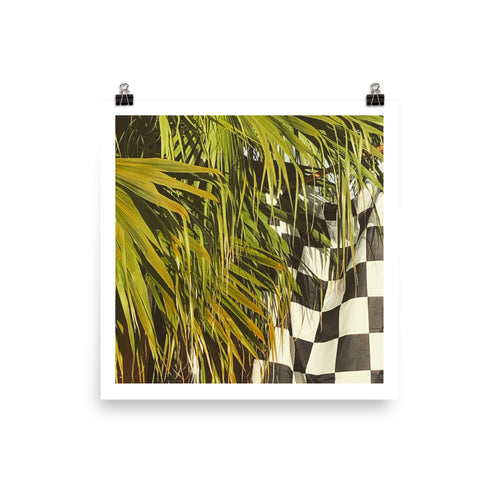 A print of a photograph of Sabal Palm Fronds against a black and white checkered flag taken by Nate DeWaele in 2020