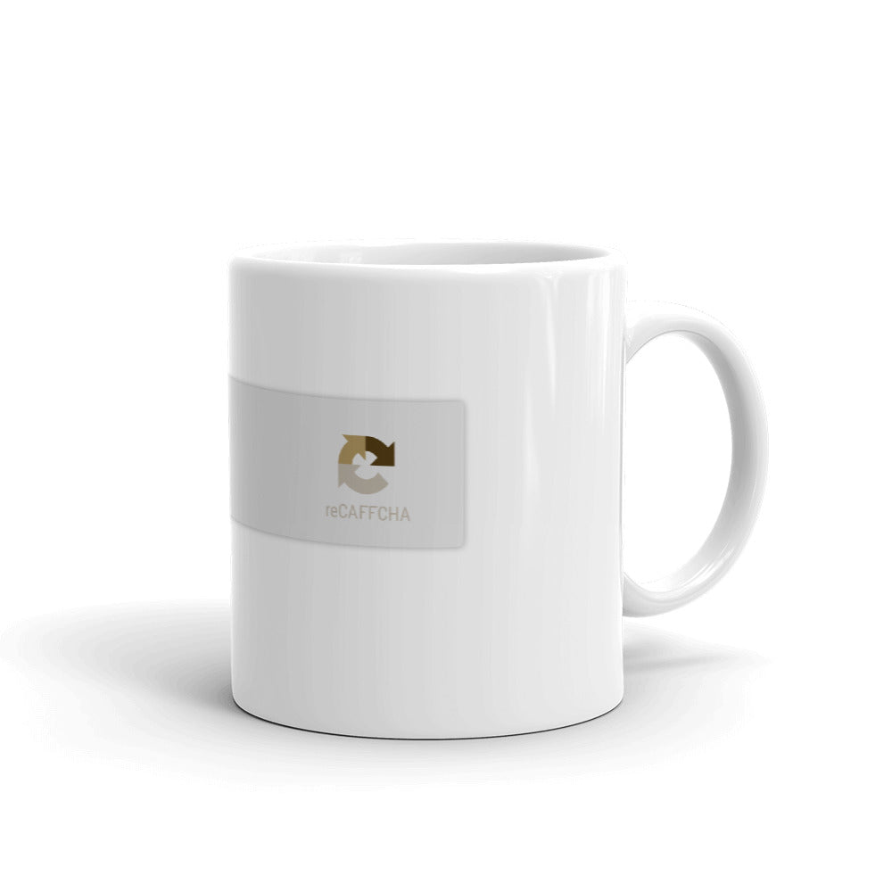 A mug with recaptcha UI that has a green checkmark indicating the drinker is not a robot- photographed and designed by Nate DeWaele - 11oz handle on right view of product