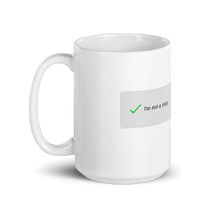 A mug with recaptcha UI that has a green checkmark indicating the drinker is not a robot- photographed and designed by Nate DeWaele - 15oz handle on left  view product